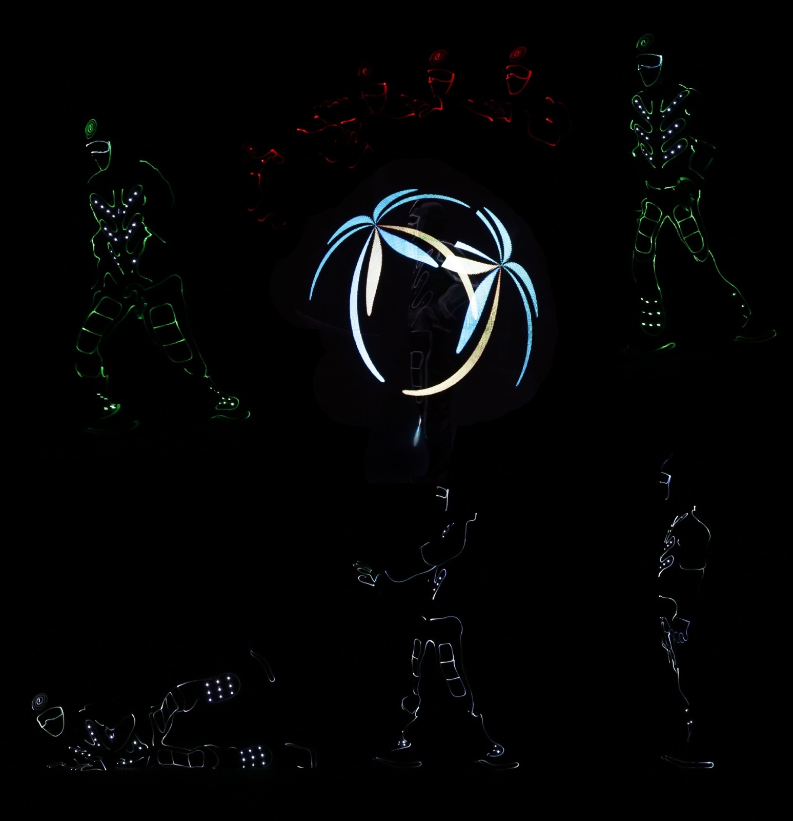 Performers in LED costumes spread across a dark stage, one framed by a glowing palm-shaped graphic.