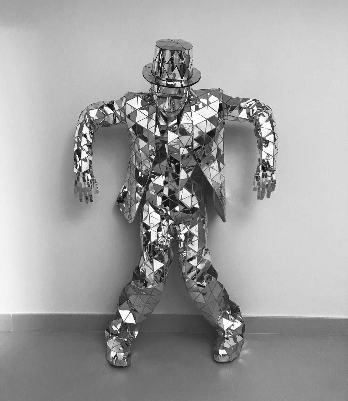A mirrored mosaic costume shown standing in full against a plain wall.